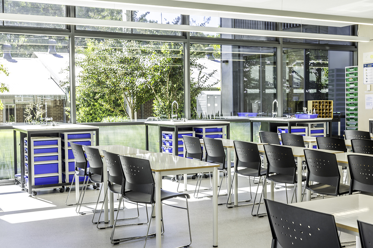 Bright education fitout with custom workstations and mobile storage cabinetry