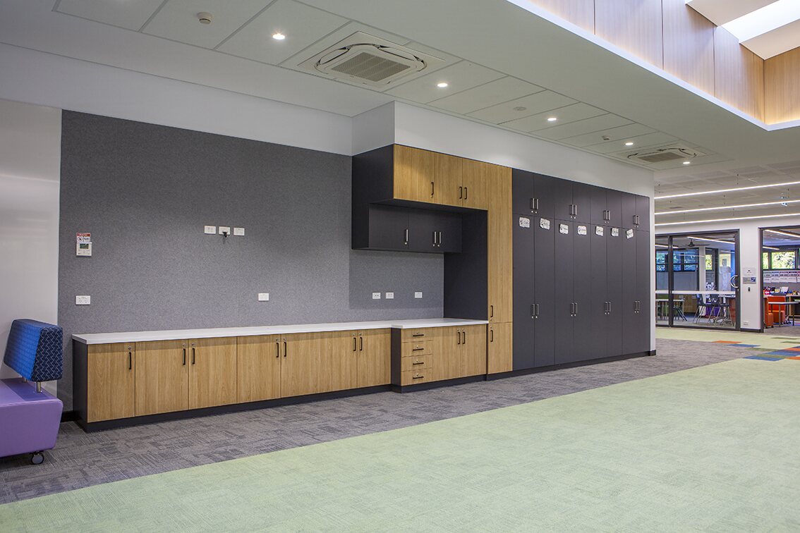 Long run of timber and charcoal commercial cabinetry