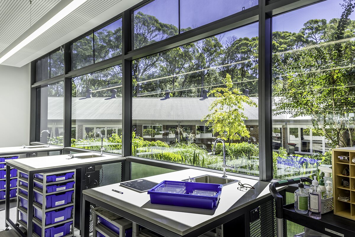 Science laboratory joinery beside full-height windows