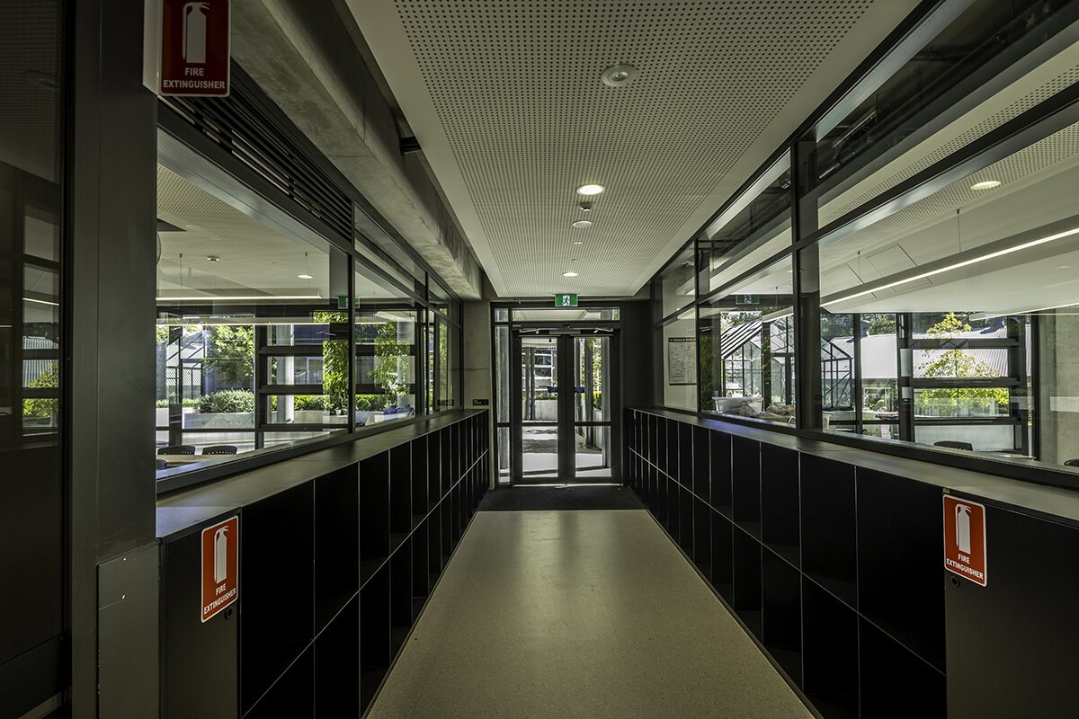 Glazed learning corridor with custom dark joinery